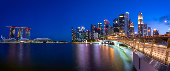 Obraz na płótnie Canvas Ultra wide panorama of Cityscape of Singapore Marina bay area at dusk.