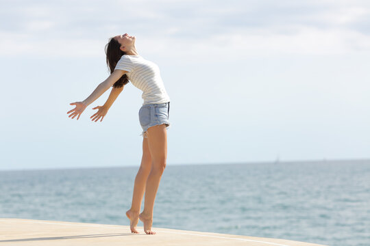 Excited woman with long legs breathing fresh air