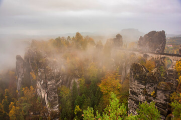 Amazing scenery of the Bastei bridge, Saxon Switzerland National Park, Germany. Autumn foggy day