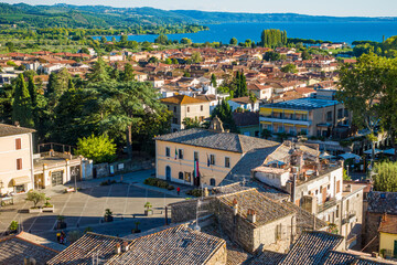 Fototapeta premium Bolsena, Italy - The old town of Bolsena on the namesake lake. An italian visit in the medieval historic center and at the port. Here in particular The Aerial View.