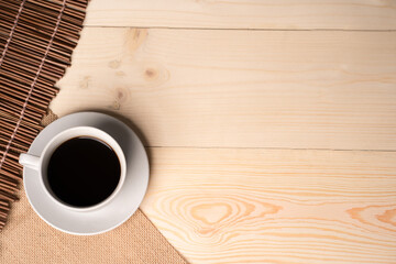 warm cup of coffee on brown background