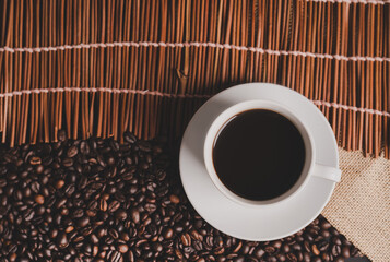 warm cup of coffee on brown background