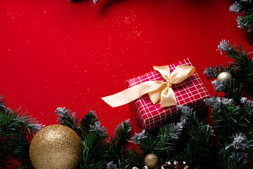 Frosted Christmas tree branches on red background