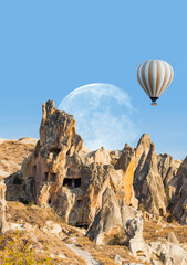 Fototapeta na wymiar Hot air balloon flying over spectacular Cappadocia with full moon 