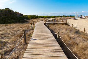 Fototapeta na wymiar Wooden plank road off the coast of Formentera, Spain, Mediterranean sea.
