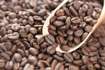  fresh coffee beans and spoon on table 