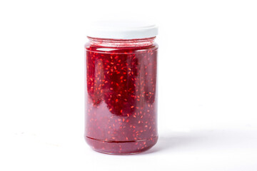 raspberry jam in a glass jar on a white background