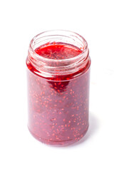 raspberry jam in a glass jar on a white background