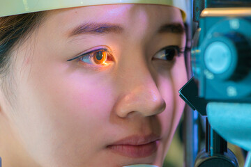 Asian student having eye test. eye test machine..