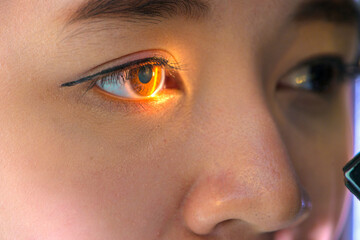 Naklejka premium woman looking at eye test machine in ophthalmologist. ophthalmologist. medical, health concept.