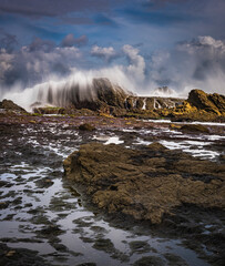 Sea water splashing to the rocks after big wave coming