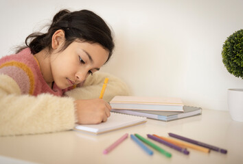 Girl painting with colored pencils