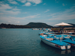 Fototapeta na wymiar Blue boats on lake Faaker
