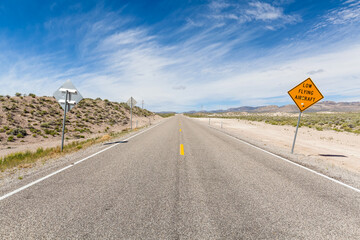 Fototapeta na wymiar Driving along the 375 - Extraterrestrial Highway there are warning signs alerting drivers to the possibility of low flying aircraft, these would be out of the Groom Lake Military base.