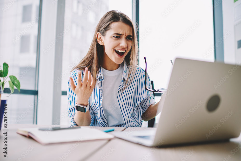 Poster angry stressed female freelancer irritated with bad internet connection sitting at desktop with netb