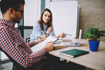 Male and female students in smart casual wear have brainstorming meeting for collaboration on university project, skilled freelance workers studying education information in coworking space