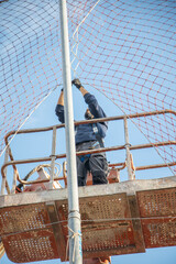 man working at heights with lifting platform.