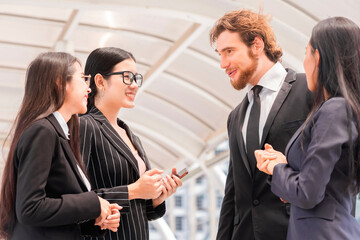 A diverse man and woman business team meeting talking and sharing their ideas at their company office building.