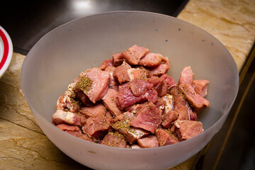 Uncooked marinated meat in a big bowl