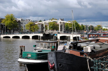 View on the famous Skinny Bridge (Magere Brug ), a bascule bridge made of white-painted wood, over...