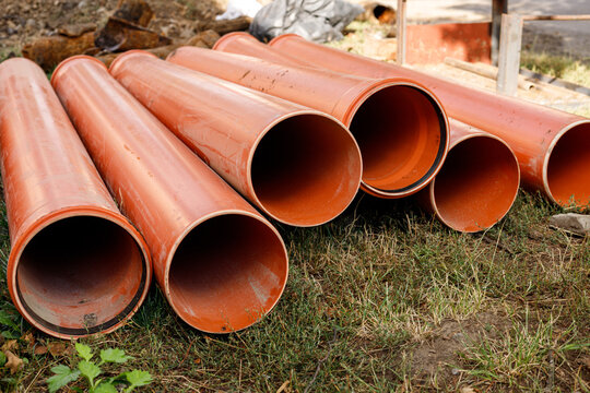 Plastic water pipes lie on the ground