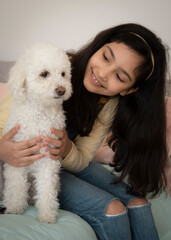 Young girl with her dog at home