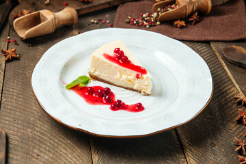 Cheesecake with berry sauce on a white plate