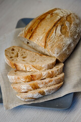 Freshly baked tartin bread cut into slices on a plate