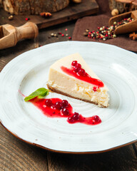 Cheesecake with berry sauce on a white plate