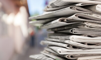 Pile of newspapers stacks on blur background