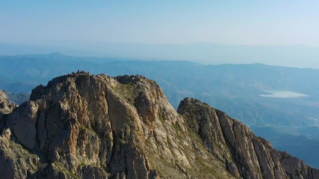 Aerial footage top of Khustup mountain, Syuniq province, Armenia.The height of the mountain is 3,206 meters.Drone's camera fly around mountain.Hikers on the top of rocks.