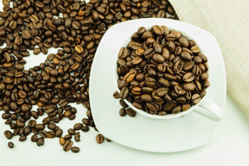 Grains of coffee in a white cup