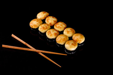 Fresh delicious beautiful sushi rolls on a dark background
