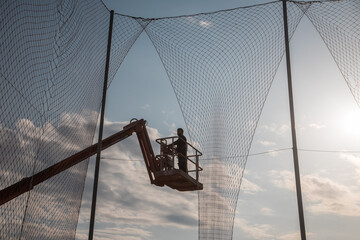 man working at heights with lifting platform.