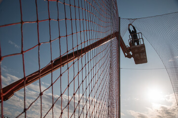 Obraz premium man working at heights with lifting platform.