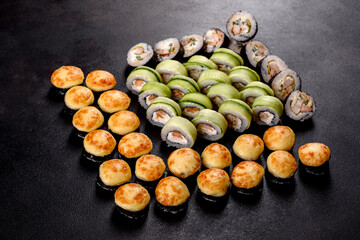 Fresh delicious beautiful sushi rolls on a dark background