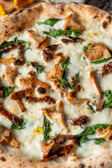 Close up of mushroom pizza with wild forest girolle and basil leaves, gourmet seasonal meal, macro texture