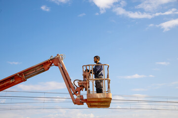 man working at heights with lifting platform.