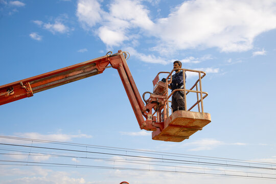 man working at heights with lifting platform.