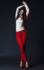 Sensual posing woman in red trousers