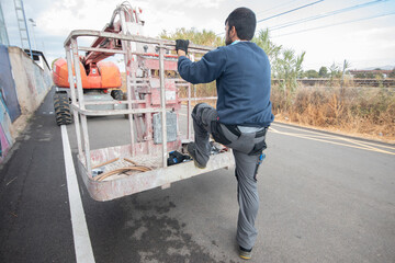 Fototapeta premium man working at heights with lifting platform.