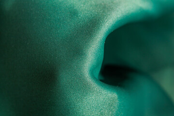 The texture of the green fabric is wrinkled.