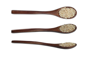 Isolate wooden eco spoon with raw brown rice on a white background