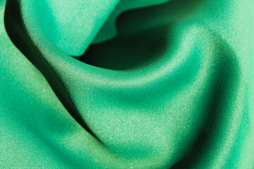 The texture of the green fabric is wrinkled.