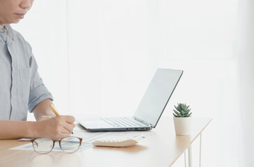 Businessman reading document at desk in office