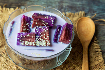 
Purple sweet potato cooked in coconut milk on wooden floor