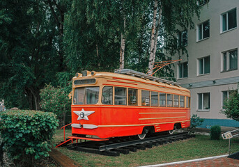 Fototapeta na wymiar Vintage Soviet tram among greenery in Perm, Russia.