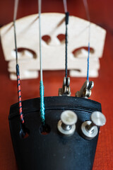 Wooden violin close up detail shot of bridge and cord tuners