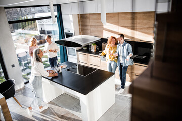 Happy woman looking at her friends on the kitchen