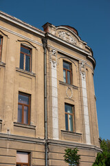 Fototapeta na wymiar 20'th Century European old building facade with decaying ornaments